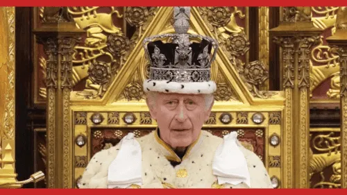 King in regal attire with crown, seated on an elaborate throne, surrounded by gold accents and intricate decorations at Pecunia 2016.